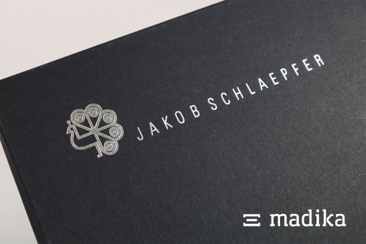 Durch die silberne Heißfolienprägung auf schwarzem Karton ist der Eye-catcher klar! Eine silberne Heißfolienprägung auf schwarzem Karton