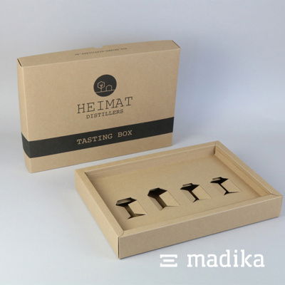 Schlichte Schachtel aus braunem Naturkarton mit schwarzer Bedruckung und individuellem Inlay. Schachtel aus braunem Naturkarton mit individuellem Inlay